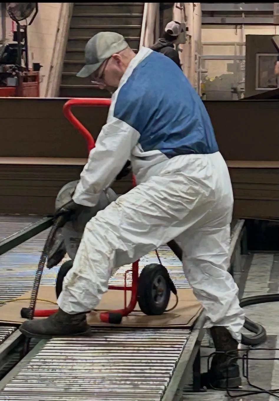 Plumber operating drain cleaning machine for service call