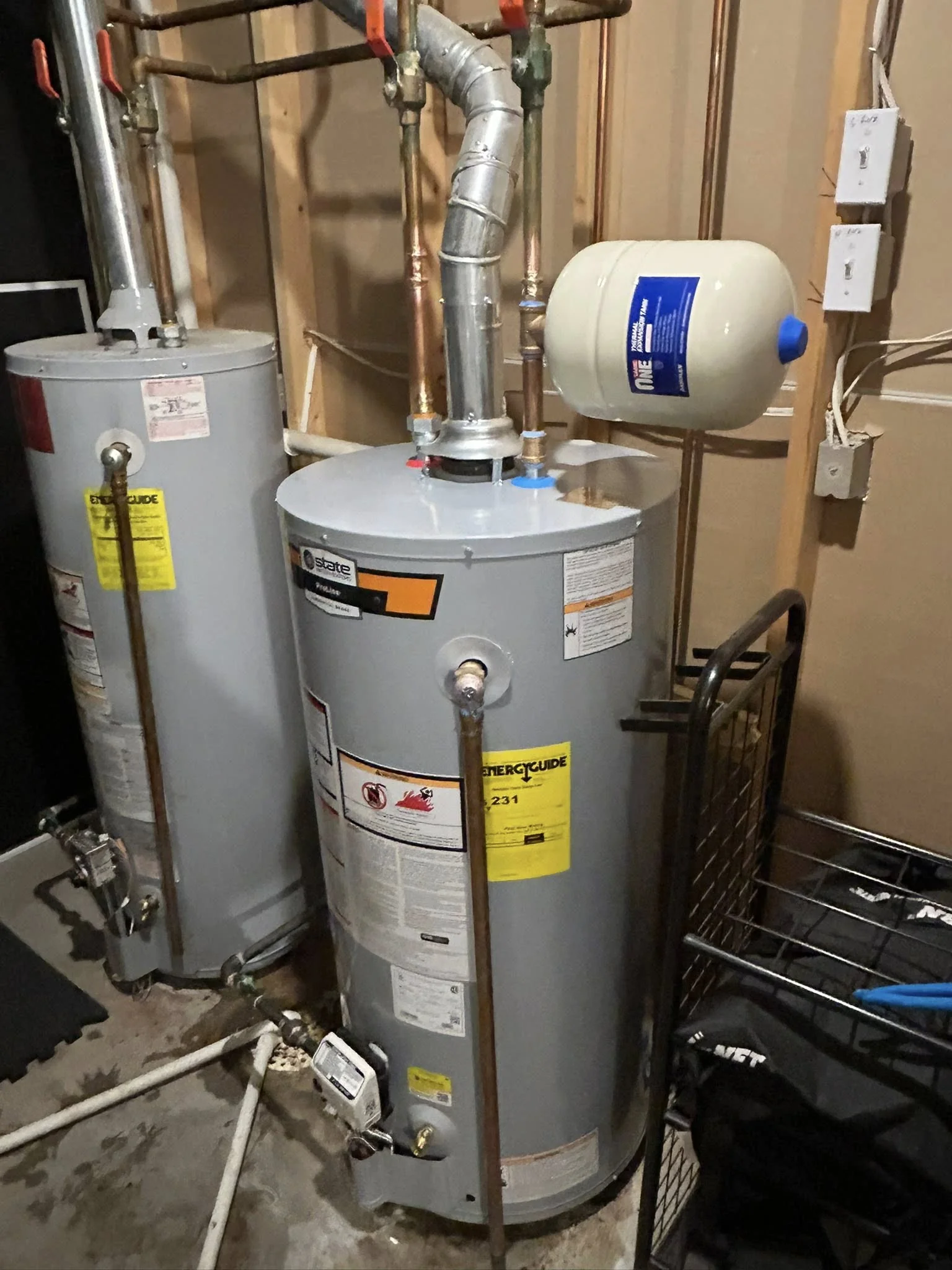 Pair of residential water heaters installed in basement utility room